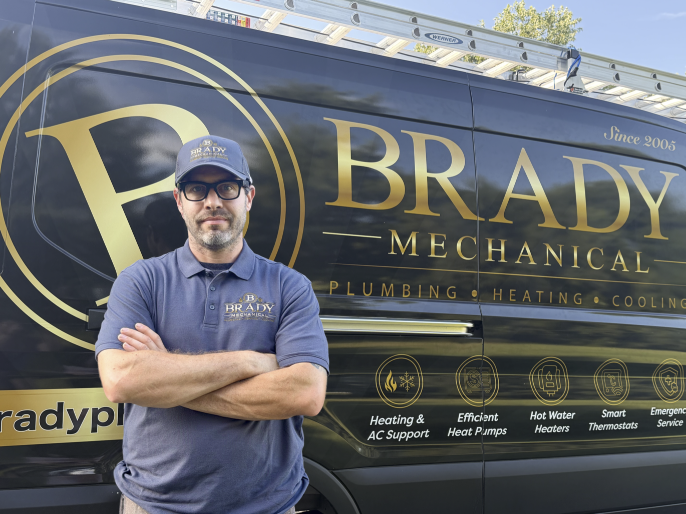 Brady Mechanical technician standing in front of a company service van
